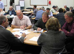 Groups of people engaged in discussions around tables.