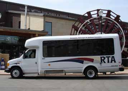 White RTA bus parked in front of a paddle wheel display.