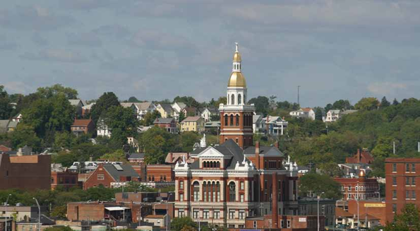 View of a city with a prominent building featuring a gold dome.