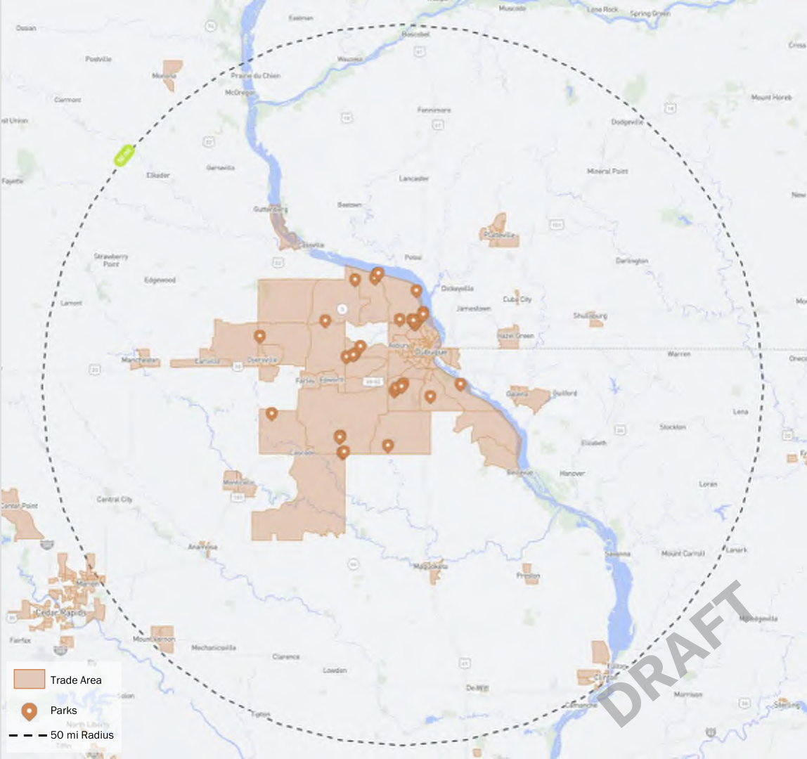 The map illustrates a trade area outlined in brown with parks marked as orange points scattered throughout the region. A dashed line indicates a 50-mile radius from the central point, represented by a white circle. The map provides spatial context for understanding the distribution of parks in relation to the trade area, enhancing the visibility of nearby recreational areas.
