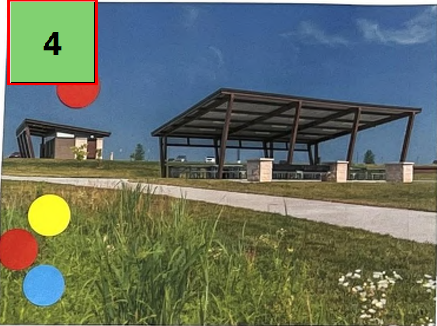 The image depicts a large shelter structure situated on a grassy area. It has a metal frame and is equipped with tables underneath. A paved path leads towards the structure, which is in an open environment with some green grass and scattered flowers. In the top left corner, there are circles colored red, yellow, and blue, with the number '4' contained in a green square.