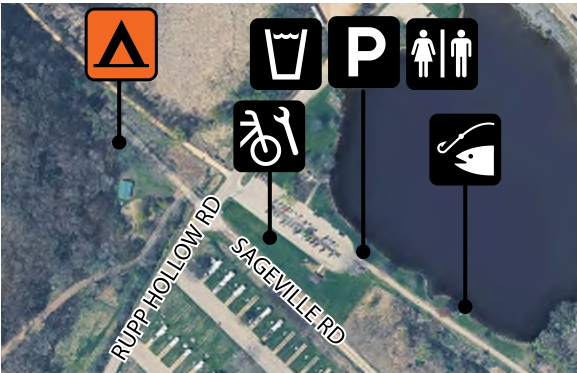 The map depicts an area around a pond with various amenities marked by icons including camping, drinking water, parking, restroom facilities, bicycle access, and fishing areas. Roads are labeled, including Rupp Hollow Road and Sageville Road, providing context to the location of features.
