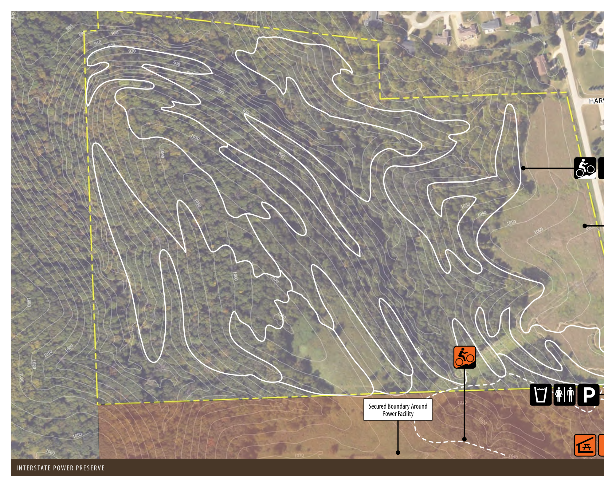 The map illustrates the topographical features of Interstate Power Preserve with contour lines indicating elevation changes. It includes a secured boundary around the power facility, labeled elevation points, and designated areas for biking and parking. The boundary and landmarks are marked to help navigate the preserve's terrain effectively.