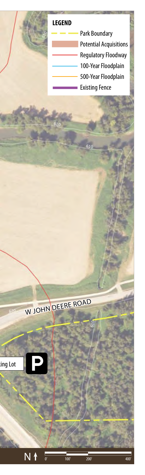The map displays a geographic layout showing the park boundary marked in red, areas designated for potential acquisitions, regulatory floodway, and floodplain areas identified as 100-year and 500-year floodplains. An existing fence is also indicated. The map includes a parking lot labeled 'P' and the road name W John Deere Road at the bottom. A north arrow and scale bar are provided for orientation, aiding in spatial understanding.