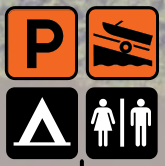 Icons indicating parking, boat launch, camping area, and restrooms with gender symbols.